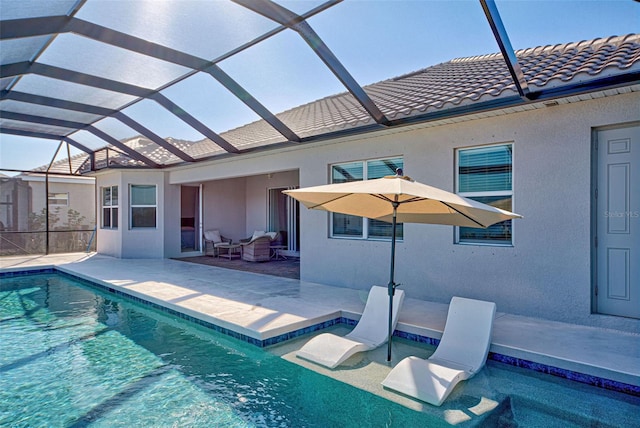 view of swimming pool with a lanai and a patio area