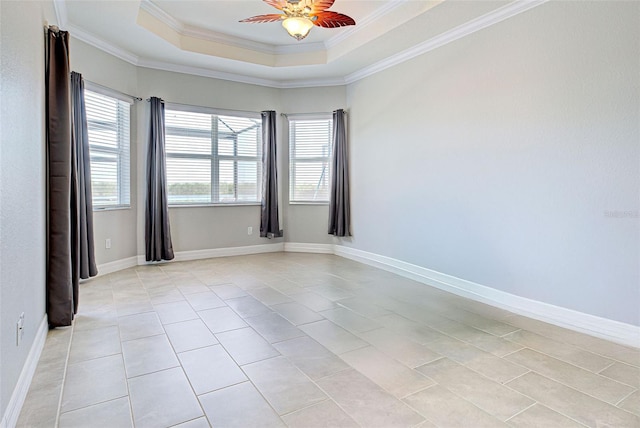 unfurnished room featuring light tile patterned floors, a tray ceiling, ornamental molding, and ceiling fan