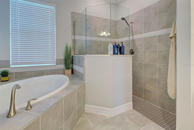 bathroom with tile patterned floors and separate shower and tub