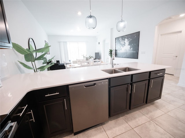 kitchen featuring light tile patterned flooring, stainless steel dishwasher, sink, and hanging light fixtures