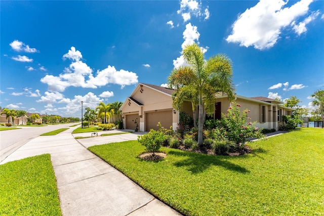 view of front of property with a front lawn and a garage