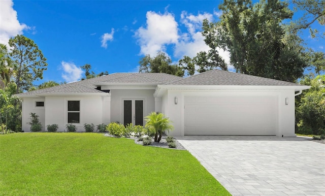 view of front of home featuring a garage and a front lawn