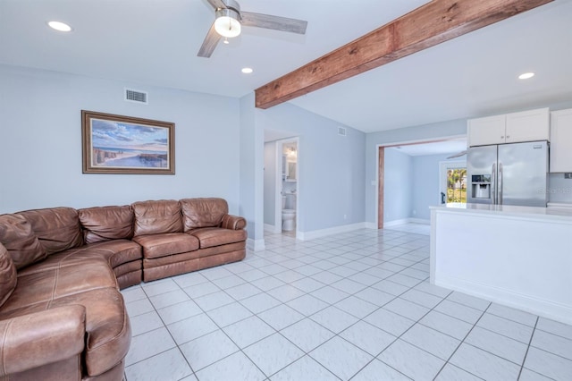 unfurnished living room with beam ceiling, ceiling fan, and light tile patterned flooring