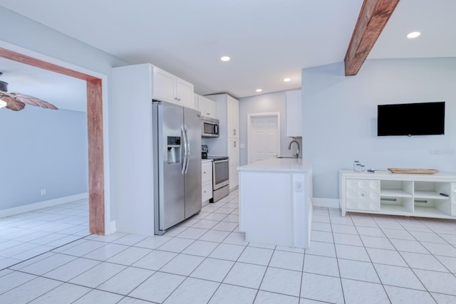 kitchen with ceiling fan, white cabinetry, light tile patterned floors, stainless steel appliances, and lofted ceiling with beams