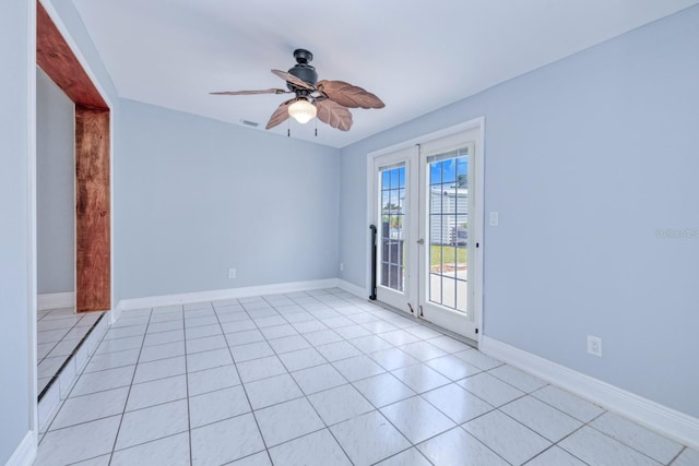 tiled empty room with ceiling fan and french doors