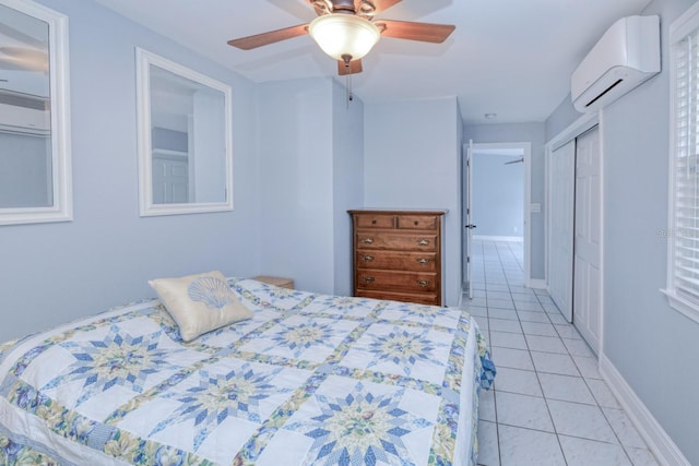 bedroom featuring light tile patterned flooring, a wall mounted air conditioner, ceiling fan, and a closet