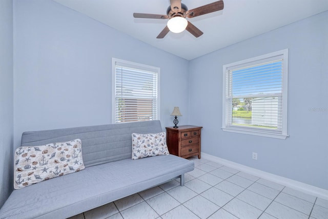 sitting room with ceiling fan and light tile patterned flooring