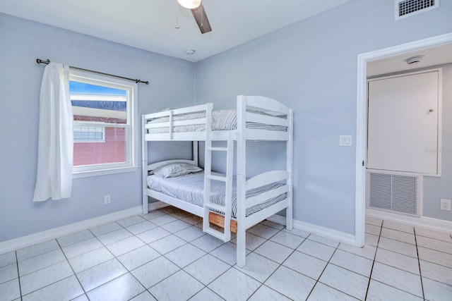 tiled bedroom featuring ceiling fan