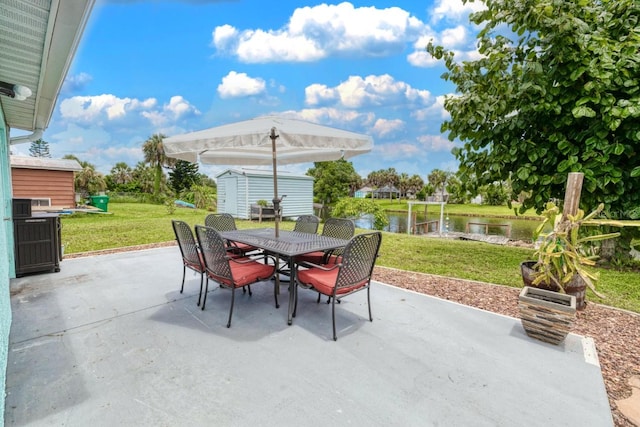 view of patio / terrace featuring an outdoor structure and a water view