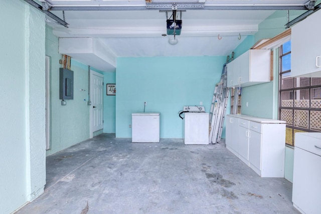 garage with fridge, a garage door opener, electric panel, and washer / clothes dryer