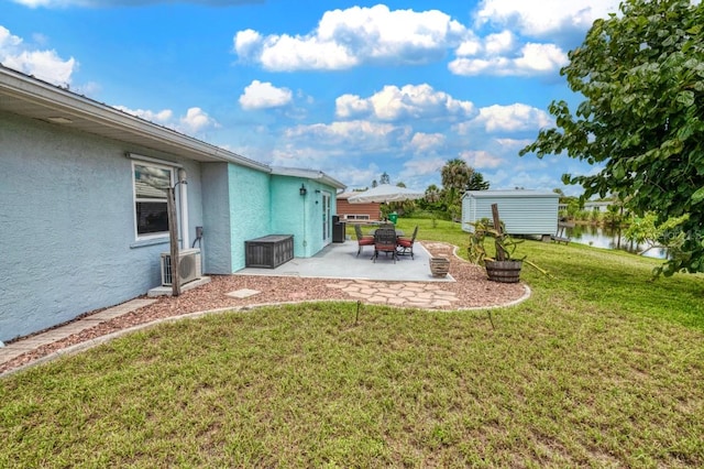 view of yard featuring a storage shed and a patio