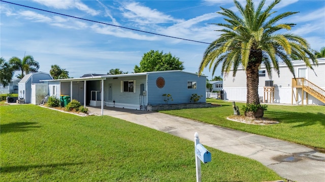 view of front of property with a carport and a front yard