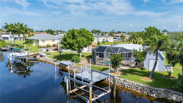 view of dock with a water view, a yard, and a lanai