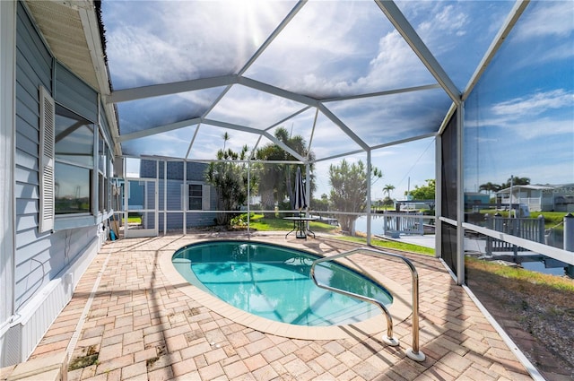 view of pool with a patio area and a lanai