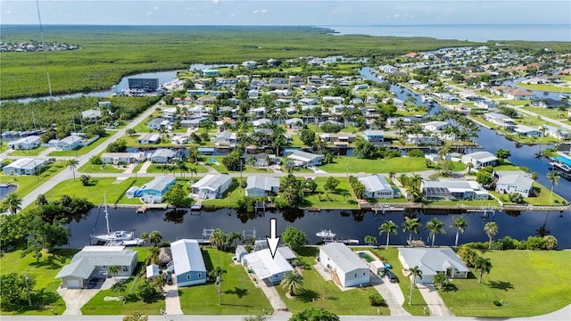 drone / aerial view featuring a residential view and a water view