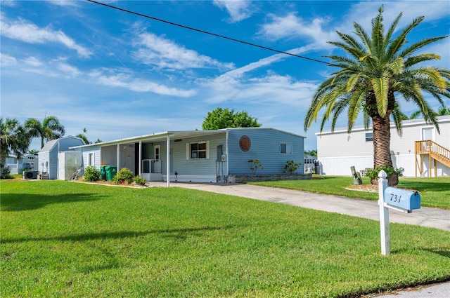 view of front facade with a carport and a front yard