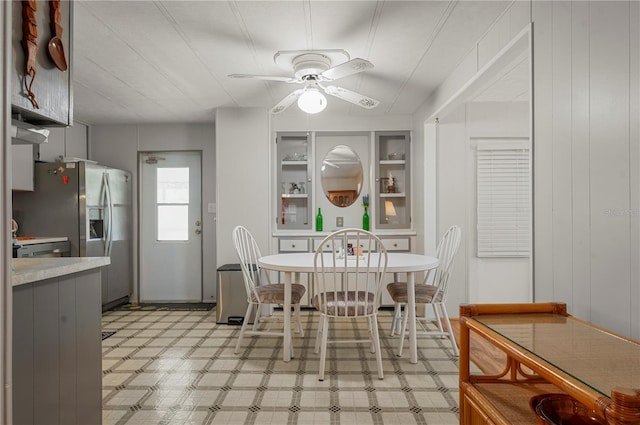 dining room with light floors and ceiling fan