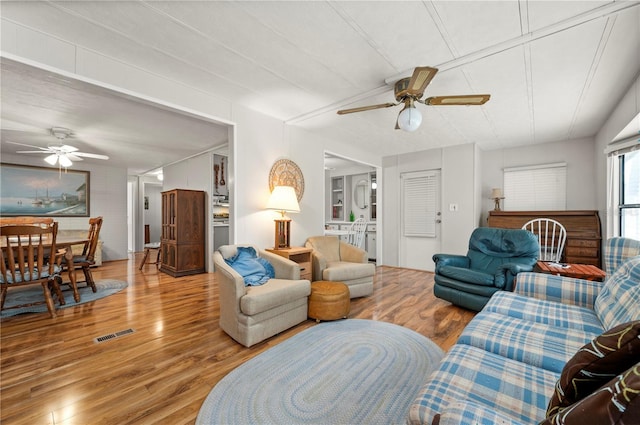 living room with ceiling fan and hardwood / wood-style floors