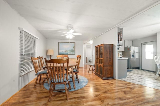 dining space with light wood-type flooring and ceiling fan