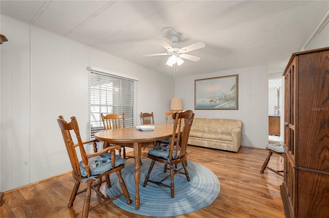 dining area with ceiling fan and light wood finished floors