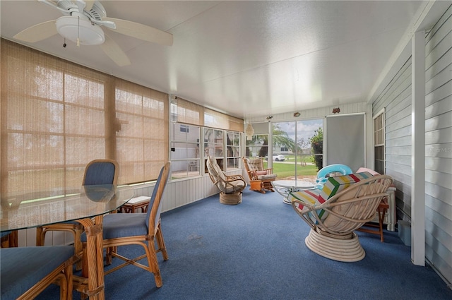 sunroom / solarium featuring a ceiling fan