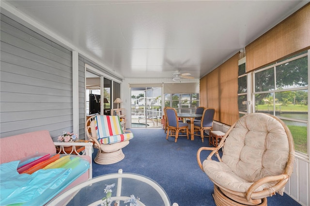 sunroom / solarium featuring ceiling fan