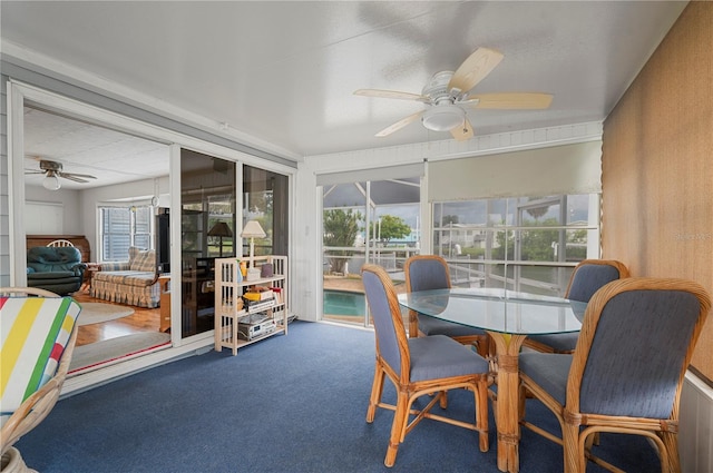 sunroom / solarium with a ceiling fan