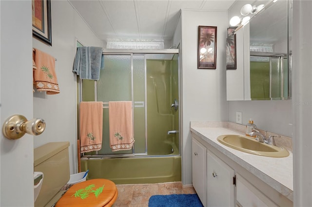 full bathroom featuring vanity, shower / bath combination with glass door, toilet, and tile patterned floors