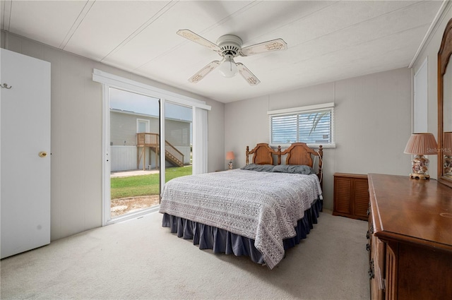 carpeted bedroom with multiple windows, access to exterior, and ceiling fan