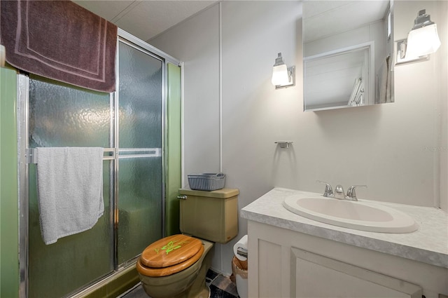 bathroom with vanity, an enclosed shower, and toilet