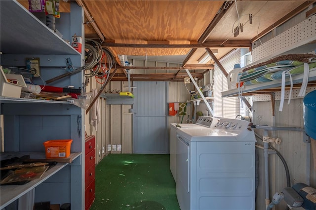 laundry area with independent washer and dryer and a workshop area