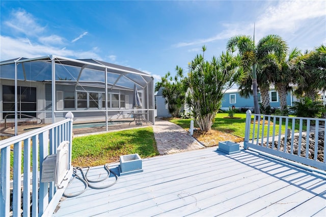 deck with a lanai, a swimming pool, and a yard