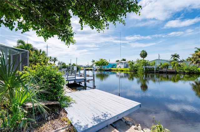 view of dock featuring a water view and glass enclosure