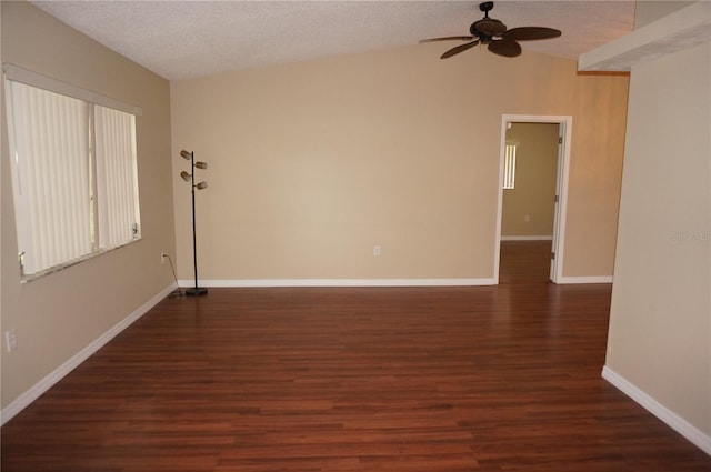 unfurnished room with dark hardwood / wood-style floors, ceiling fan, vaulted ceiling, and a textured ceiling