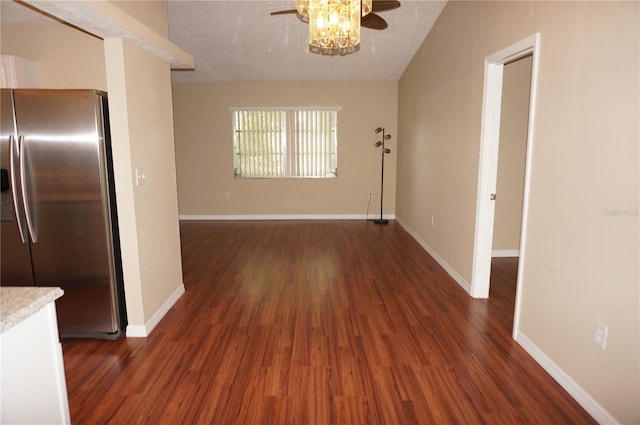 interior space featuring dark wood-type flooring and a textured ceiling