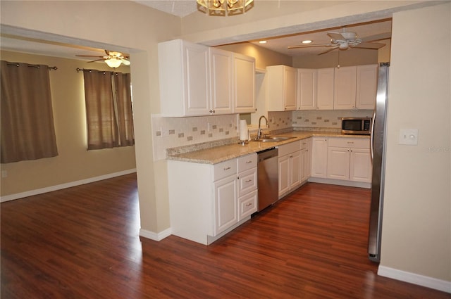 kitchen featuring appliances with stainless steel finishes, dark wood-type flooring, ceiling fan, and tasteful backsplash