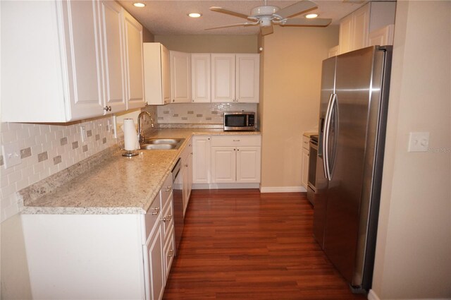 kitchen with white cabinetry, ceiling fan, dark hardwood / wood-style floors, stainless steel appliances, and sink