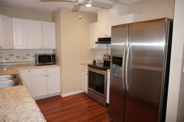 kitchen with tasteful backsplash, stainless steel appliances, white cabinets, dark wood-type flooring, and ceiling fan