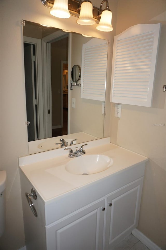 bathroom with tile patterned flooring, toilet, and vanity