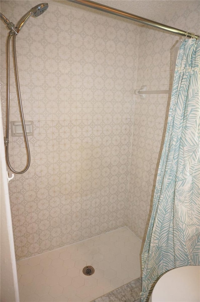 bathroom with walk in shower and toilet