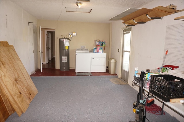 interior space featuring washing machine and clothes dryer, a textured ceiling, and electric water heater