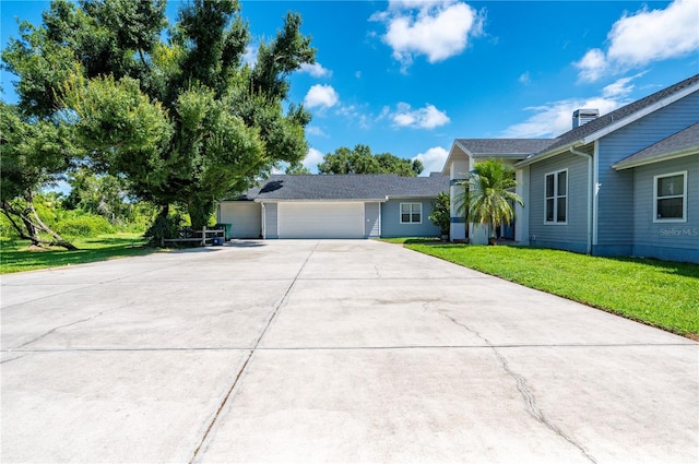 view of front of house with a garage and a front lawn