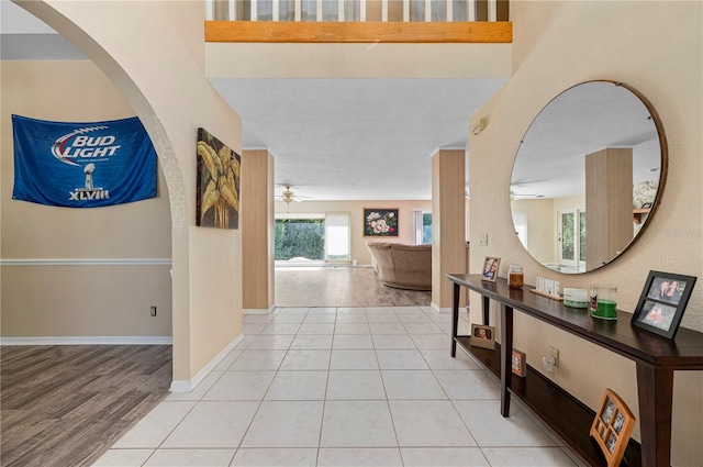 corridor featuring light hardwood / wood-style floors and a textured ceiling