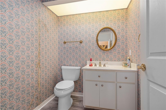 bathroom featuring vanity, hardwood / wood-style flooring, and toilet