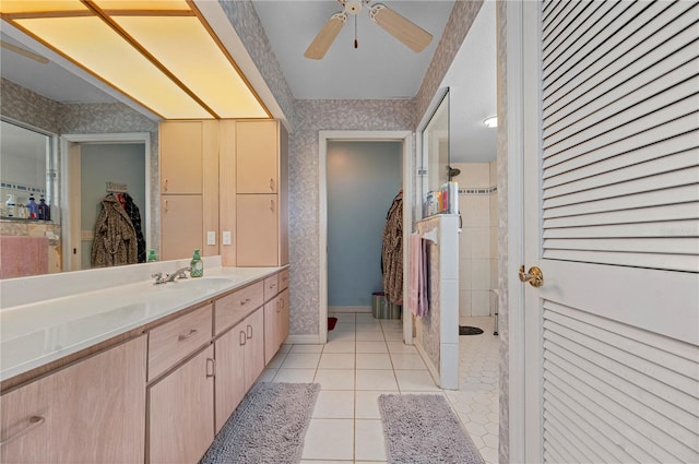 bathroom with vanity, tile patterned flooring, ceiling fan, and tiled shower