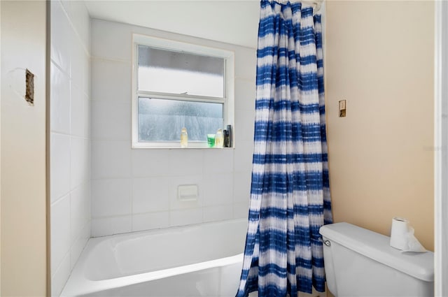 bathroom with toilet and shower / bath combination with curtain