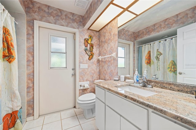 bathroom with vanity, tile patterned floors, and toilet