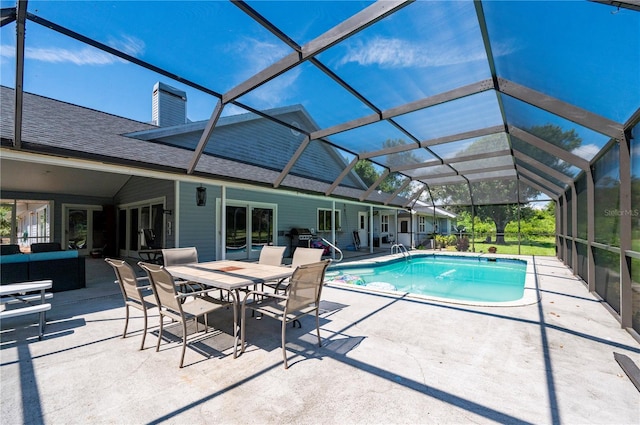 view of swimming pool featuring a patio area and glass enclosure