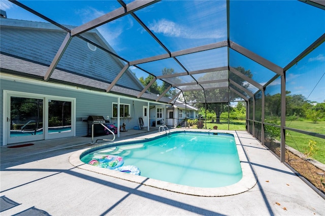 view of swimming pool with a patio area, a grill, and glass enclosure