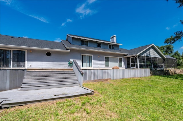 back of house with a sunroom and a lawn